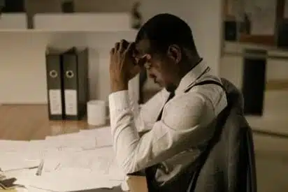 Hollywood FL Accounting Firm | CPA Tax & IRS Help Stressed man at desk calculating tax on overtime