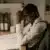 Stressed man at desk calculating tax on overtime