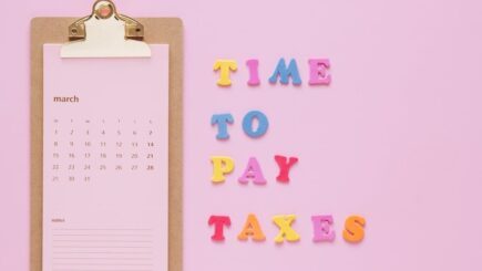 a pink clipboard with colorful letters on it