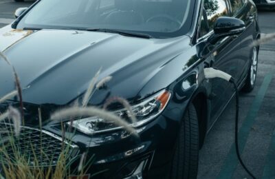 Electric vehicle charging with charging cable connected, highlighting potential EV tax credit benefits for eco-friendly transportation.