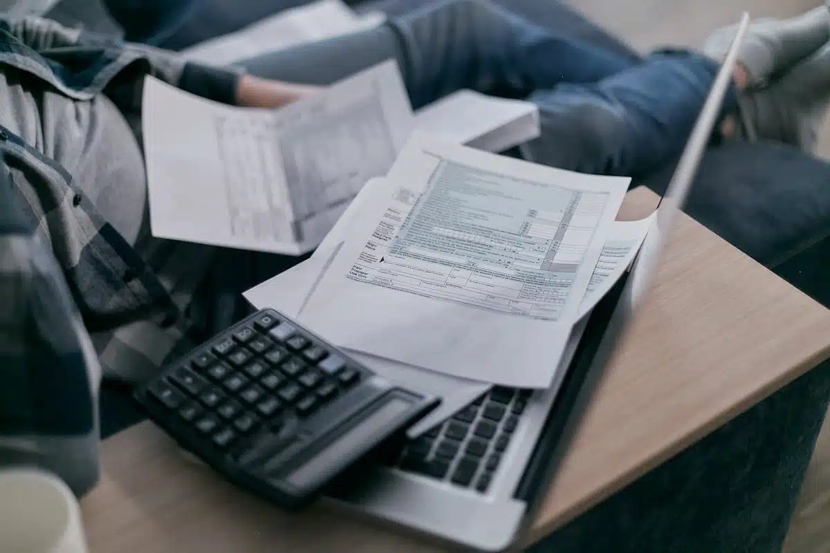 Tax documents and calculator on a desk, representing preparing an IRS Schedule E form