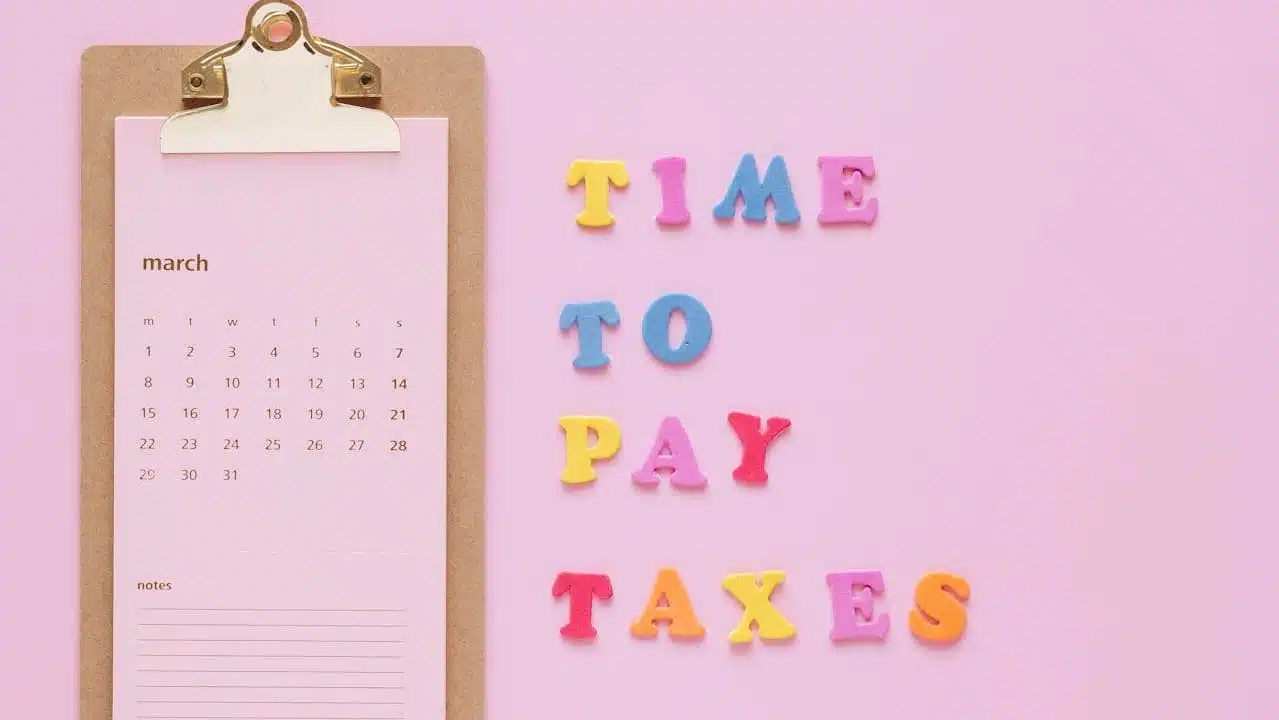 a pink clipboard with colorful letters on it